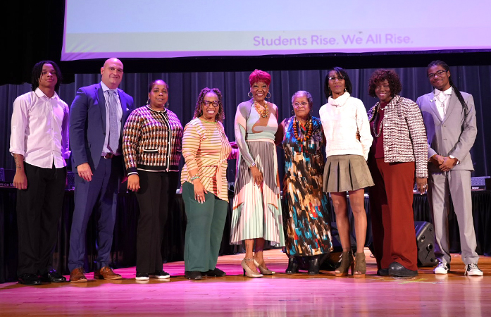 New Board Member Bessie Harris standing with current board, student board members and Dr. Vitti